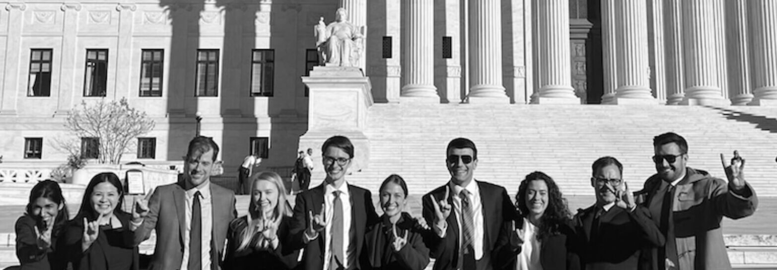 A group of people in front of the supreme court building