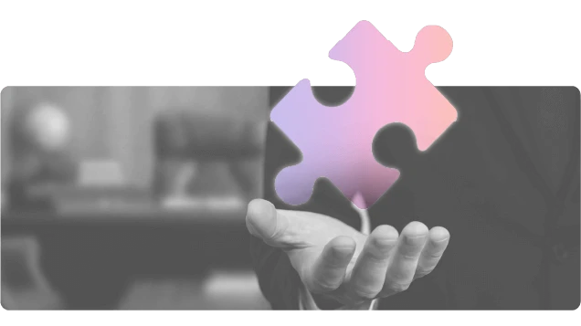 A hand holding the missing piece of a puzzle