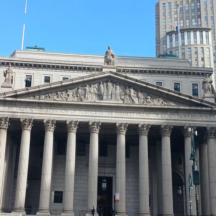 The New York County Supreme Court at 60 Centre Street in Manhattan, with its columns and the inscription over them